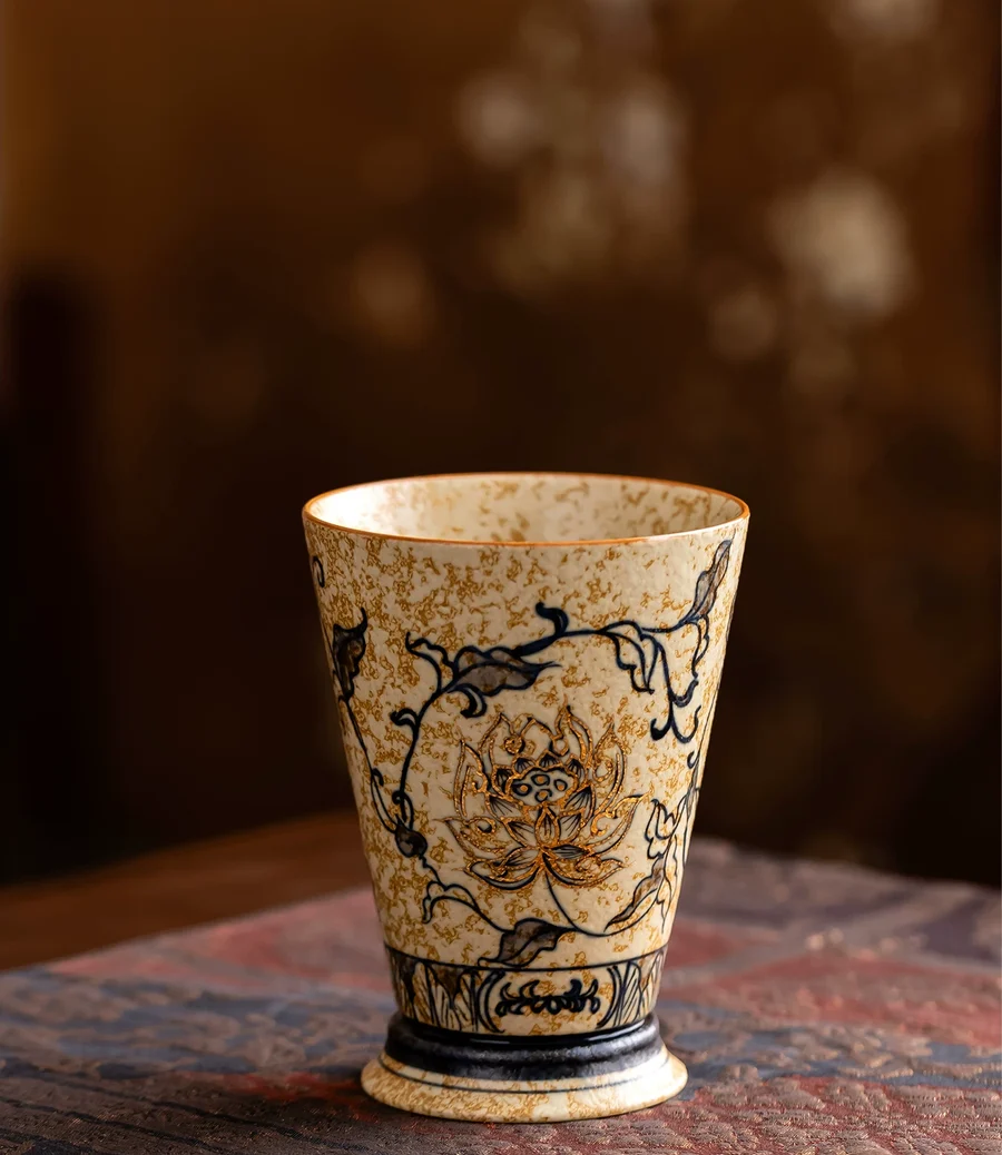 The Trailing Lotus cup resting on a patterned table covering