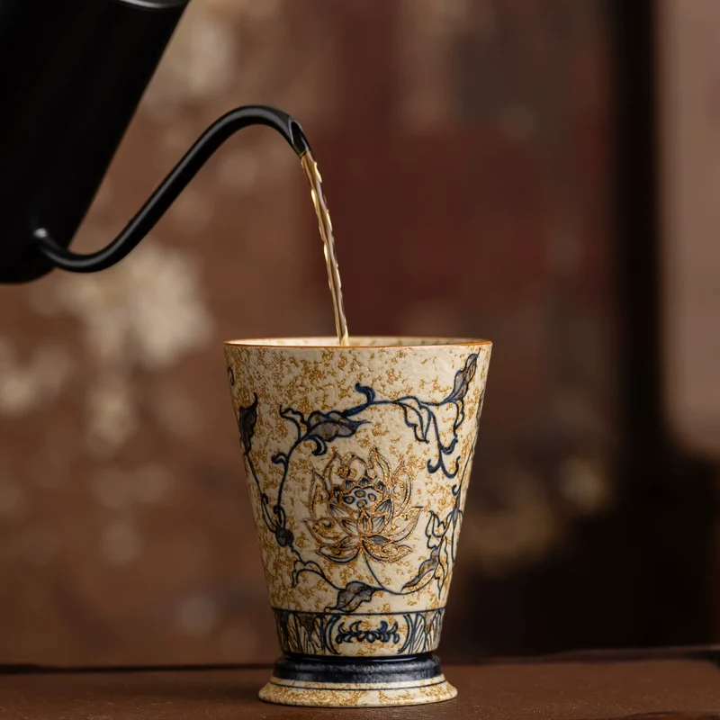 Tea being poured into a decorated porcelain cup