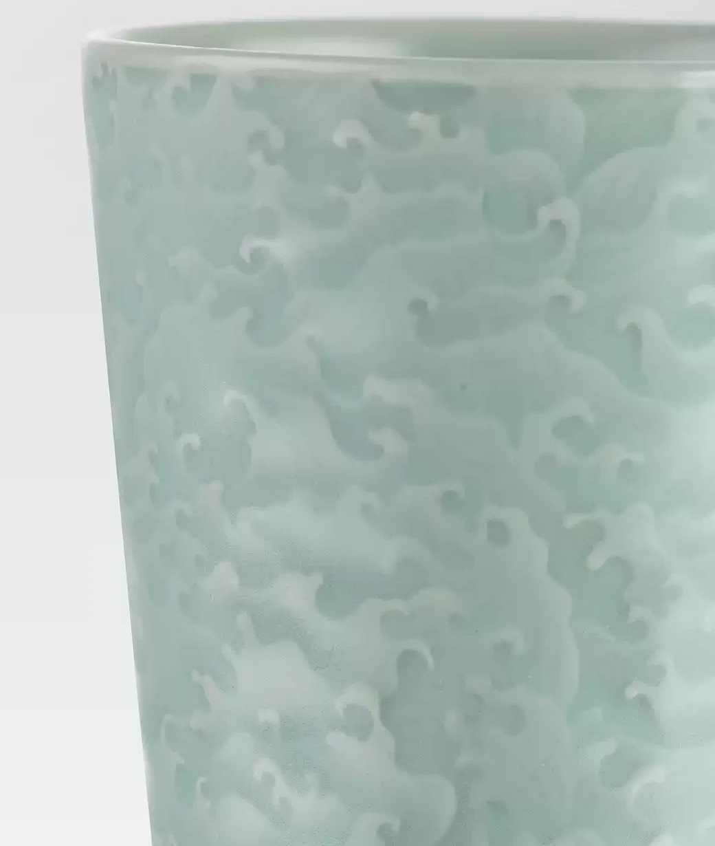 Raised wave crests across the GUANZHI cup's celadon surface